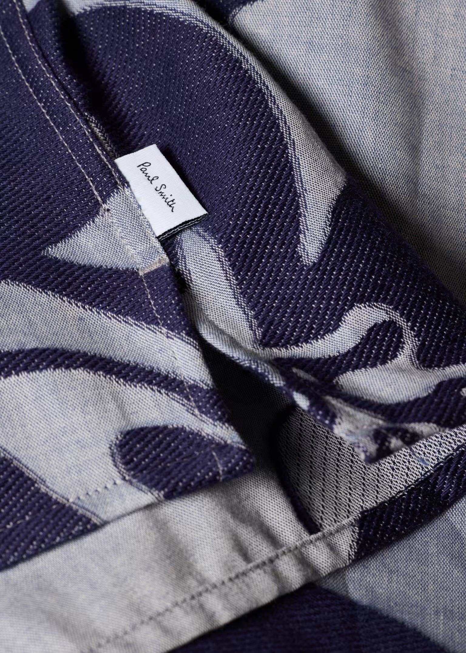 Close-up of a patterned fabric with a Paul Smith label.