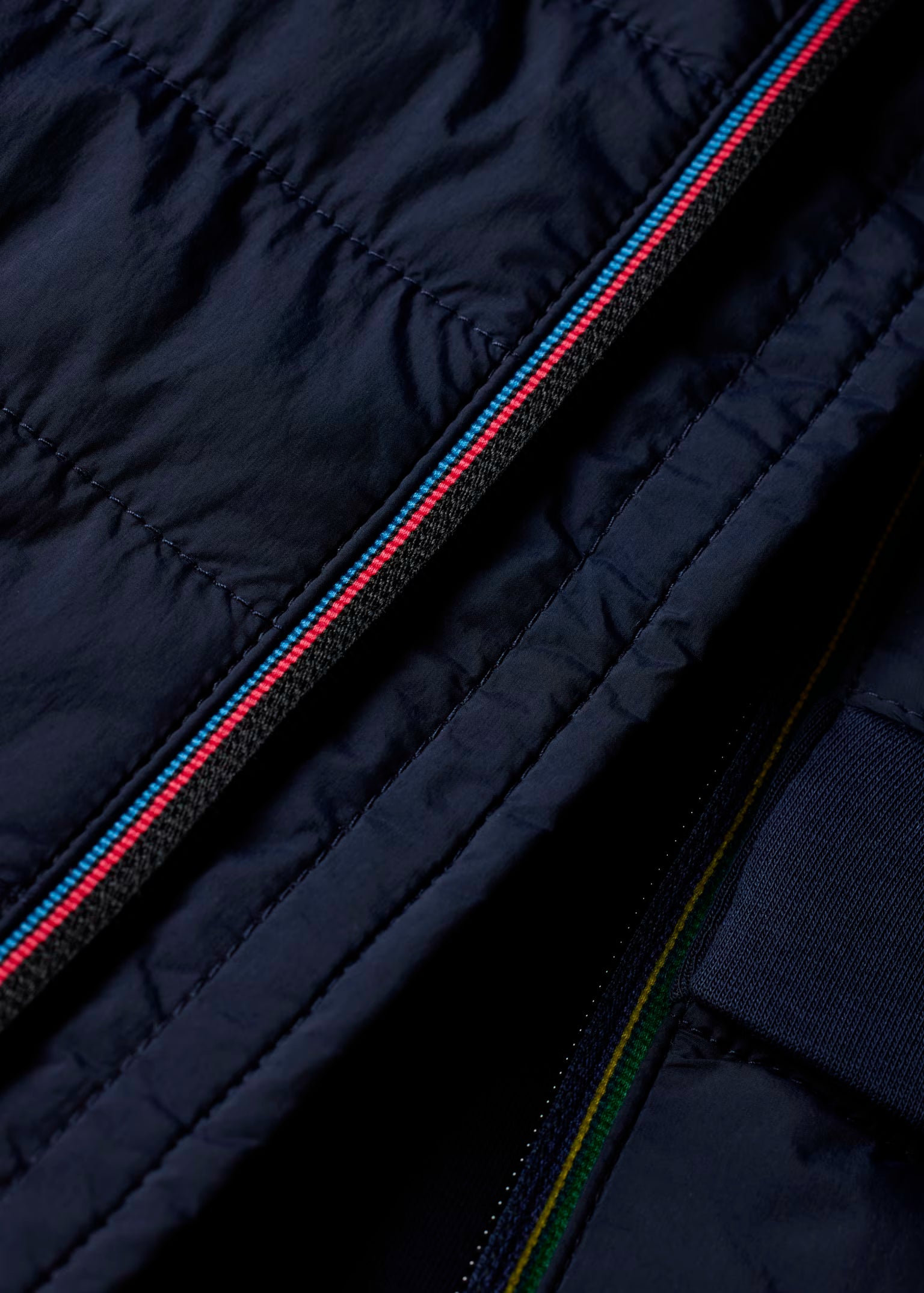 Close-up of a navy blue jacket with zipper details