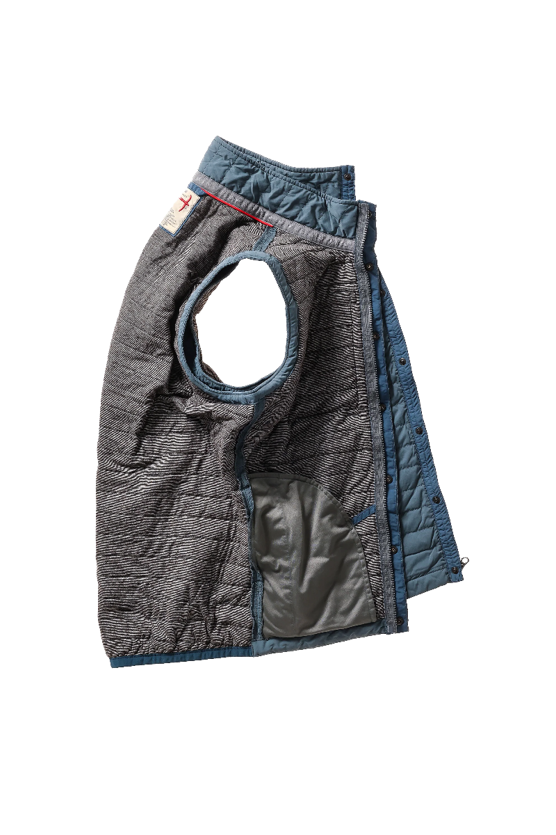 Quilted dog vest with gray and blue pattern on a white background