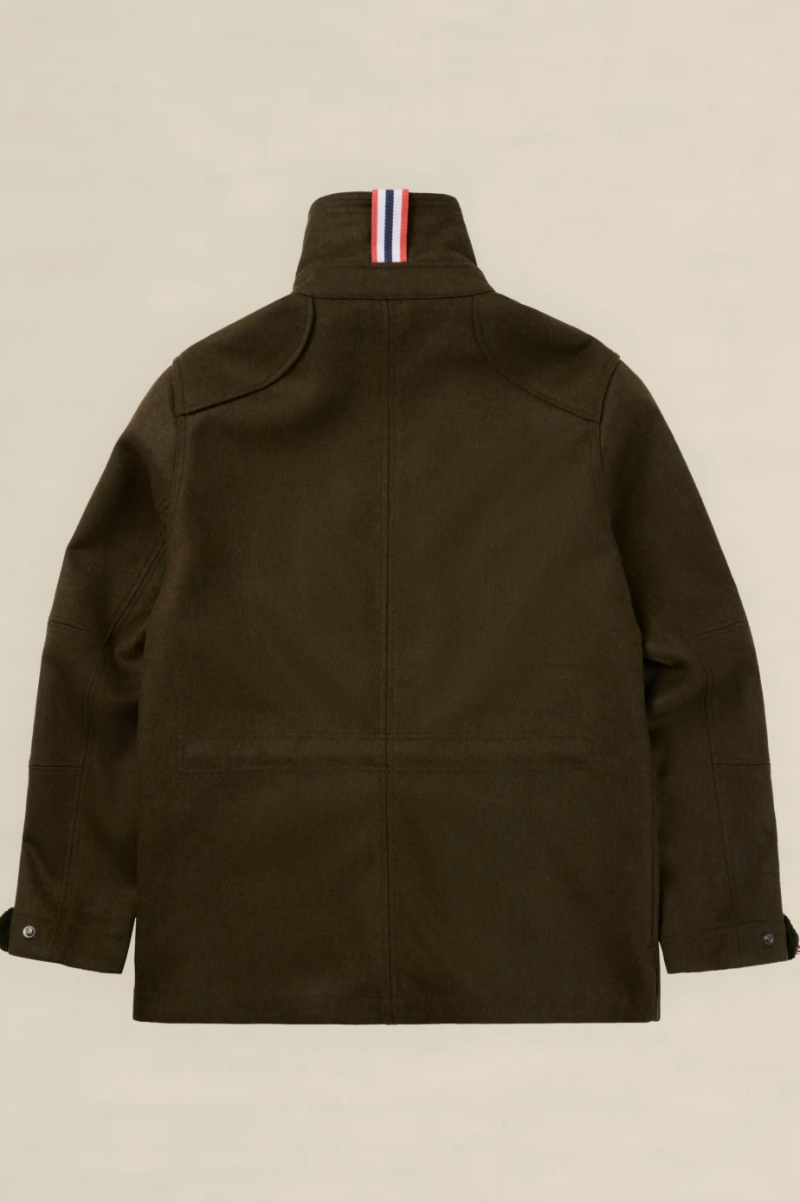 The back view of an olive green utility jacket with a high collar featuring a signature red, white, and blue striped ribbons detail, displayed on a neutral beige background.