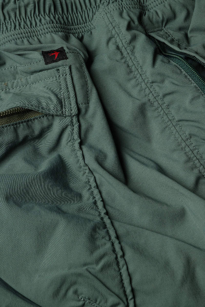 Close-up of green pants with stitching details