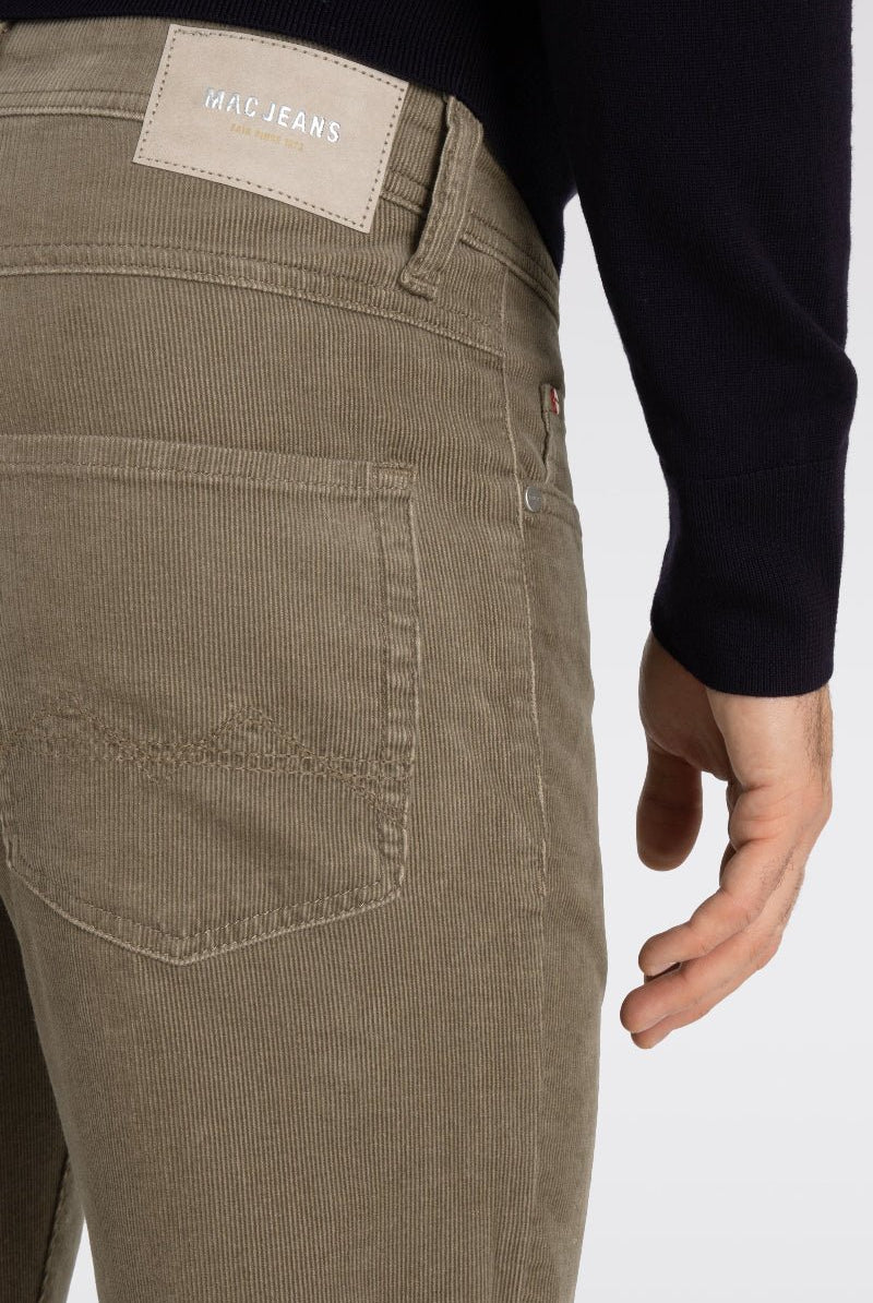 Brown pants with a visible brand label on a white background