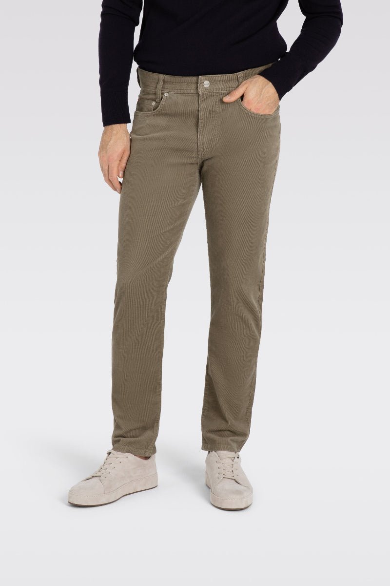 Person wearing beige pants and a black top on a white background