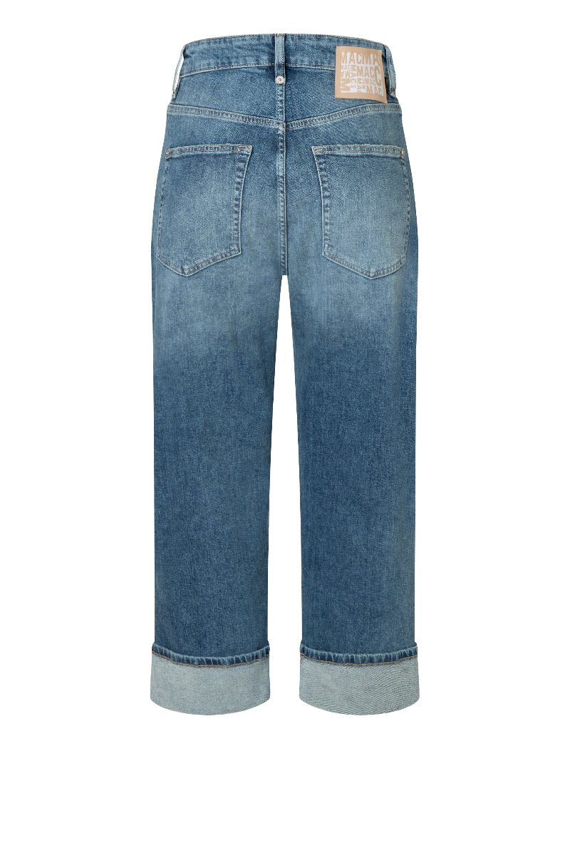 Blue jeans with a brand label on a white background