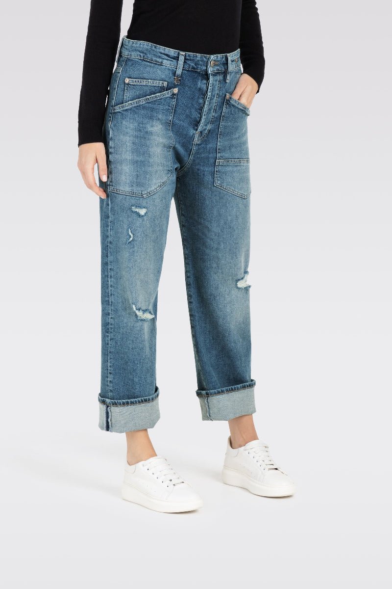 Person wearing light blue jeans on a white background