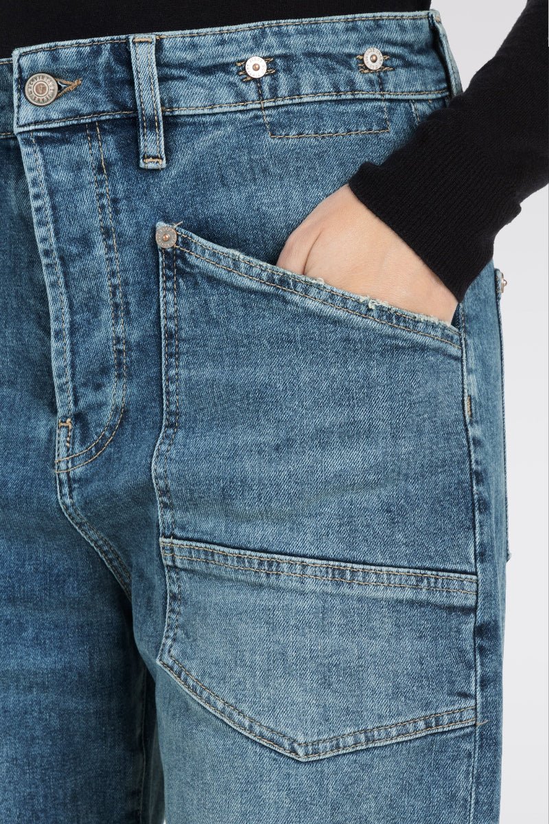 Close-up of blue jeans with a plain background