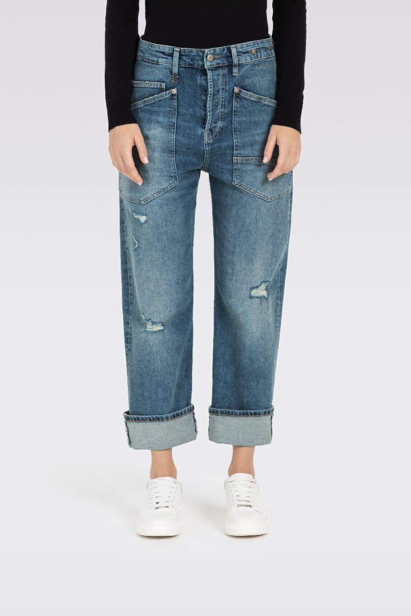 Blue jeans worn by a person on a white background