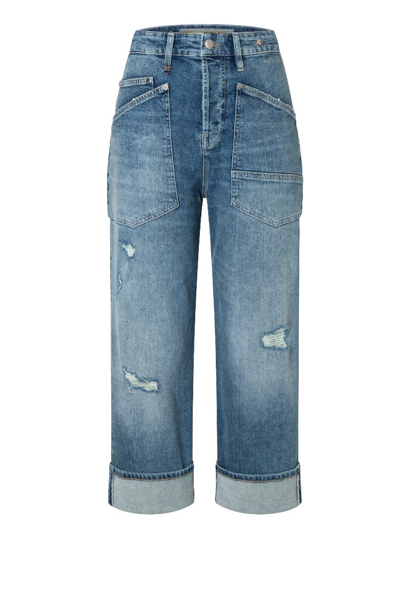Blue jeans with distressed details on a white background