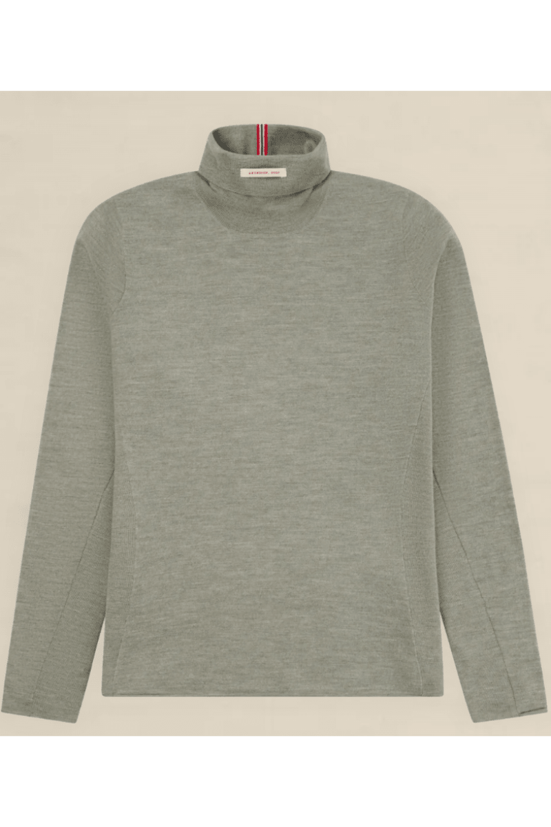 A light gray long-sleeve mock neck sweater with a subtle heathered texture, laid flat against a light beige background. A small red, white, and blue striped brand tag is visible inside the collar.