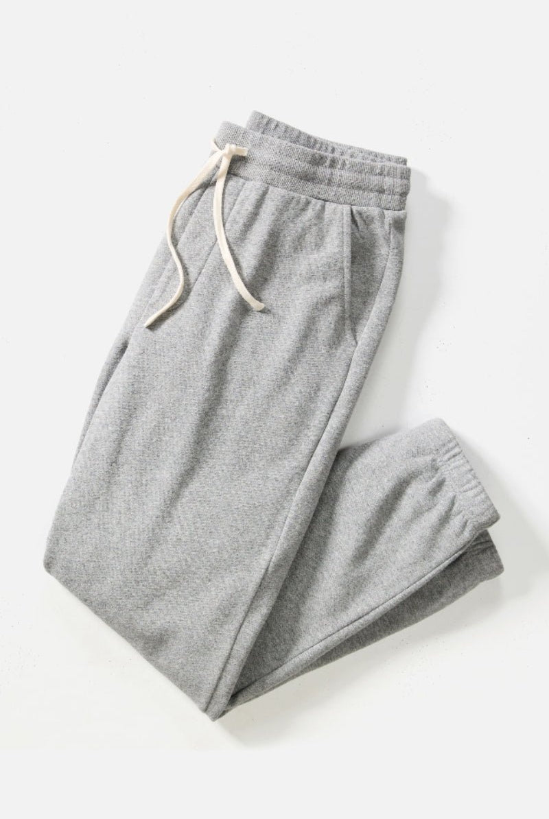 Gray sweatpants with a drawstring on a white background