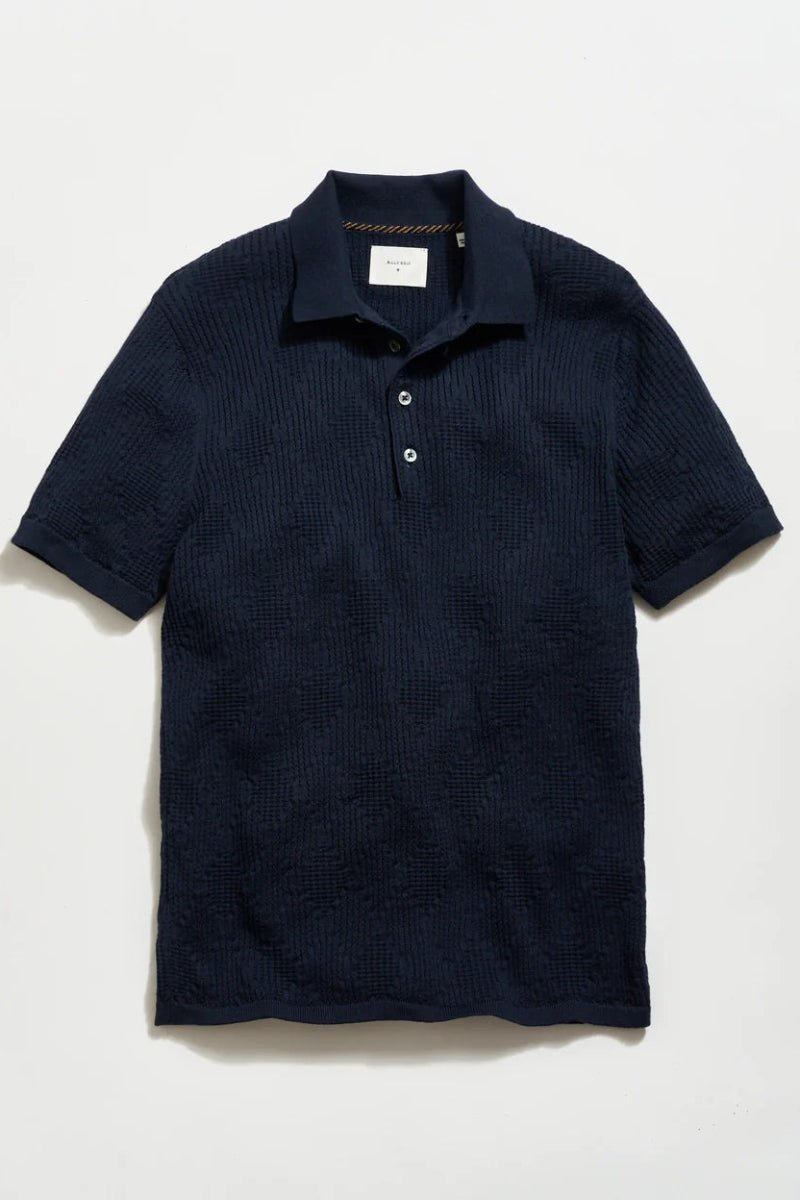 Navy blue textured polo shirt on a light gray background