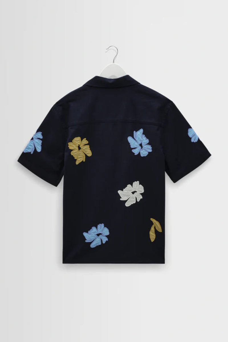 Black shirt with colorful floral patterns on a white background
