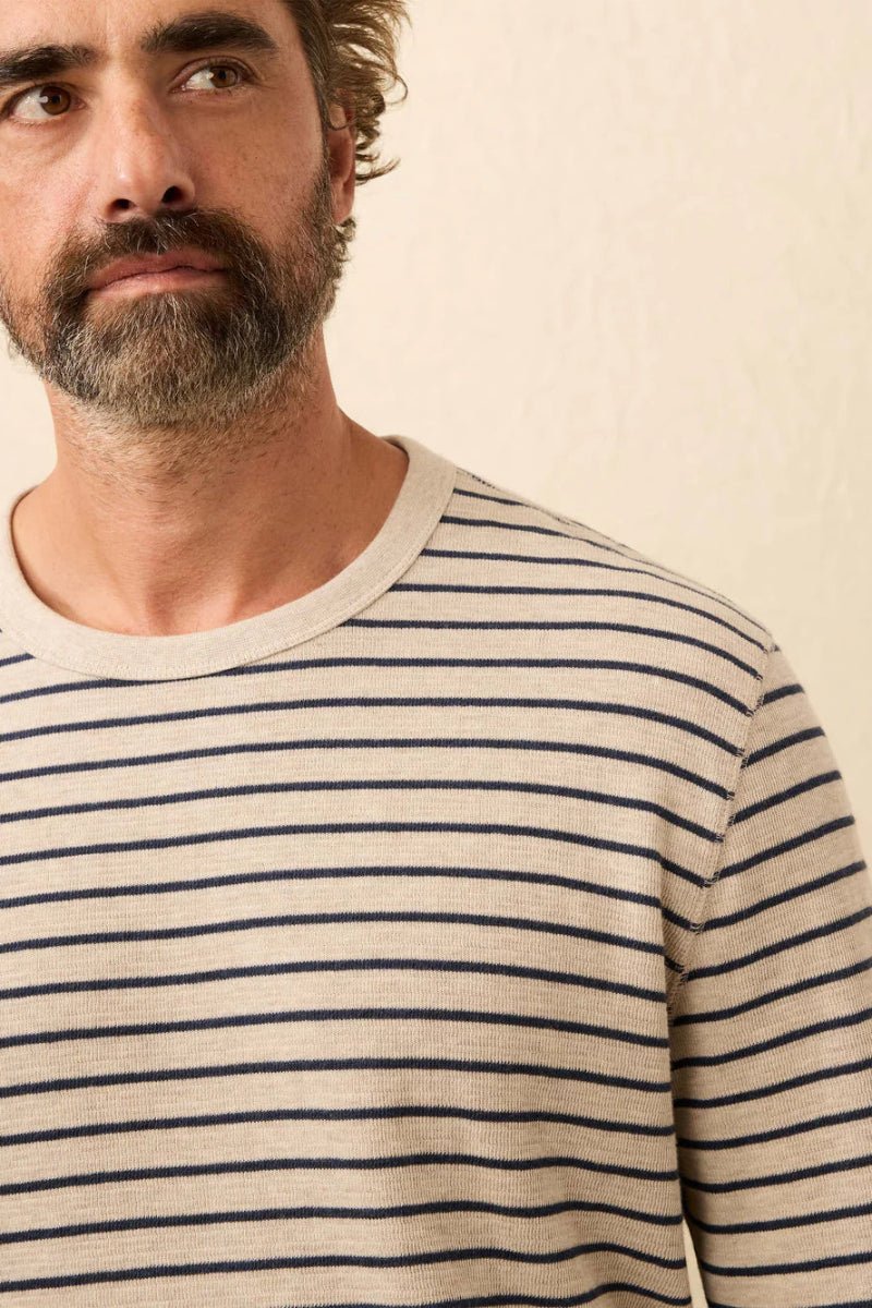 Man wearing a striped shirt against a plain background