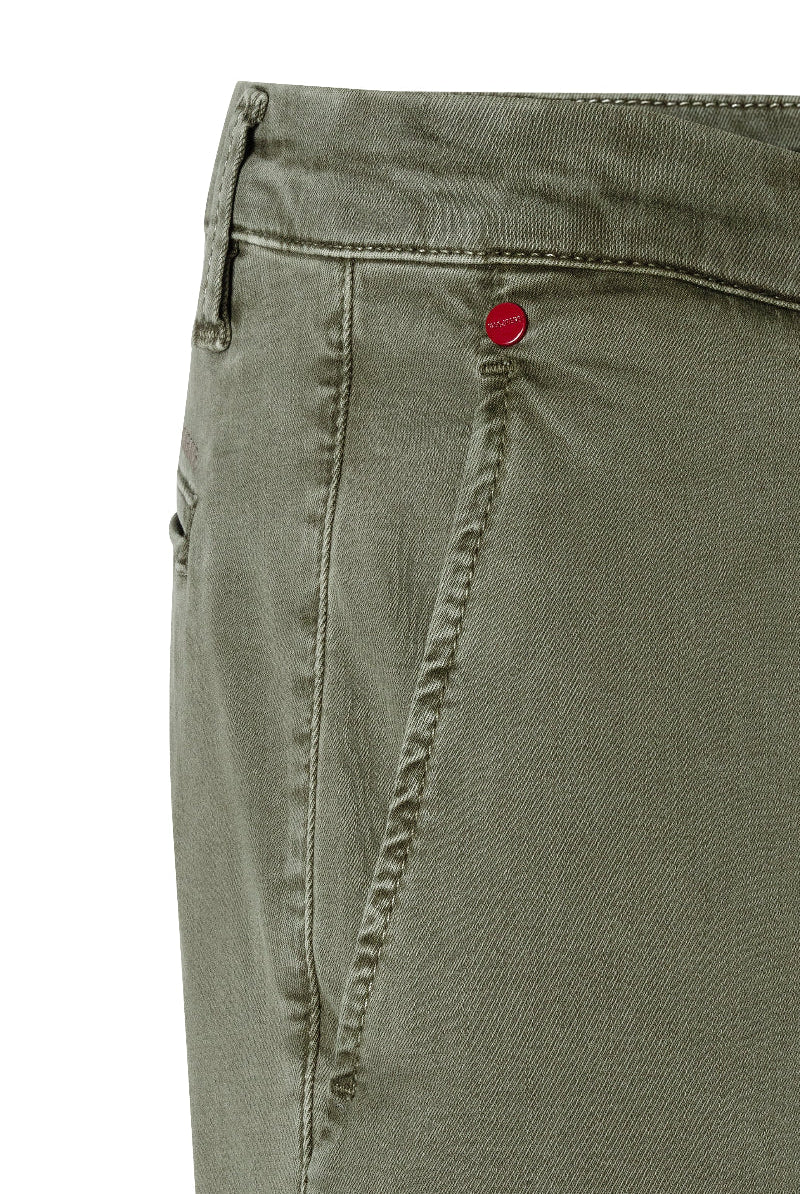Close-up of green pants with a red button on a white background
