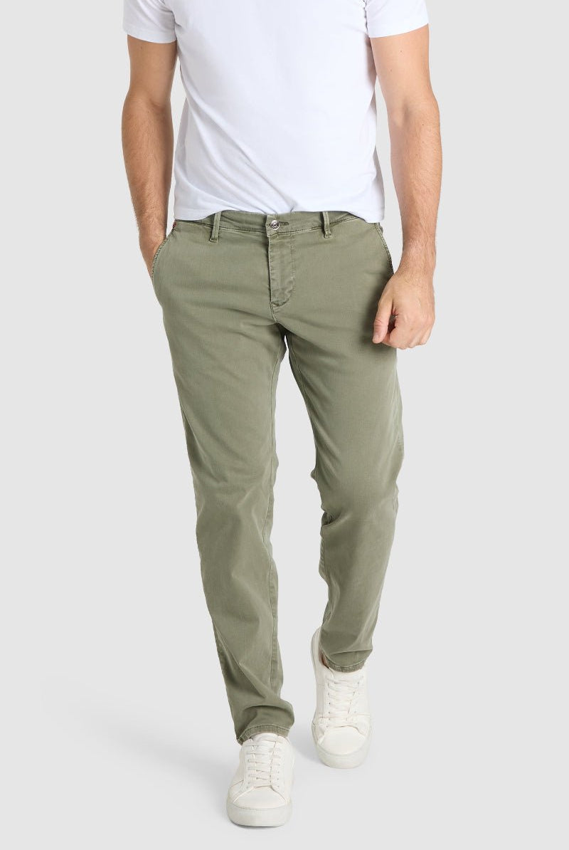 Person wearing olive green pants and a white shirt on a light gray background