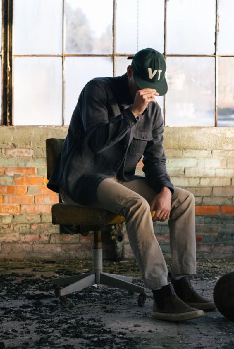 Person sitting on a chair with a ball in an industrial setting