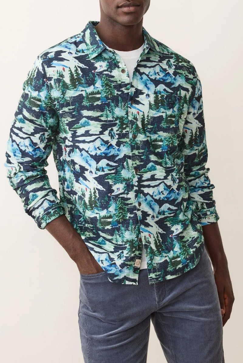 Person wearing a patterned shirt with a neutral background