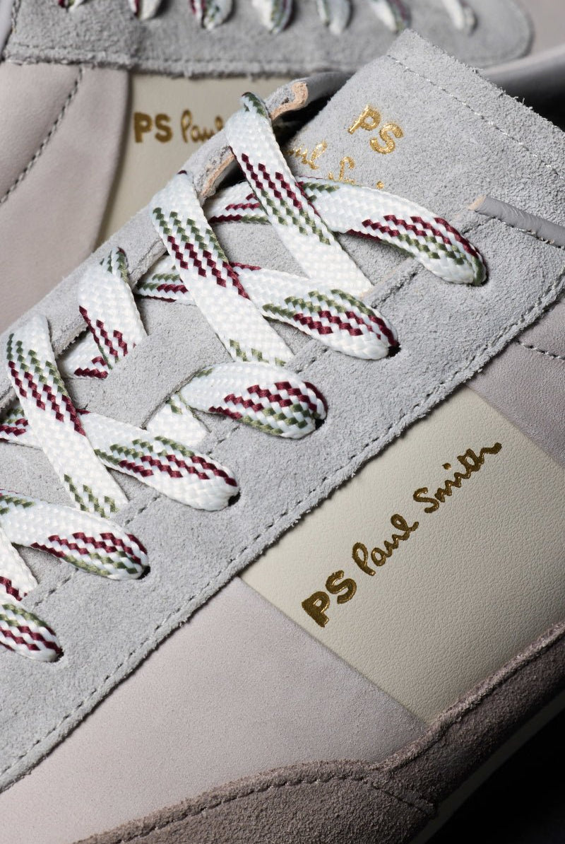 Close-up of a sneaker with white laces and 'PS Paul Smith' branding.