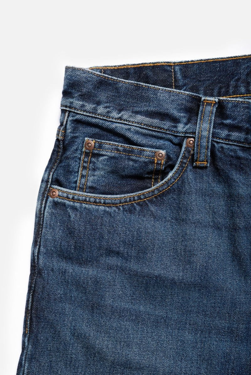 Close-up of blue jeans with a white background