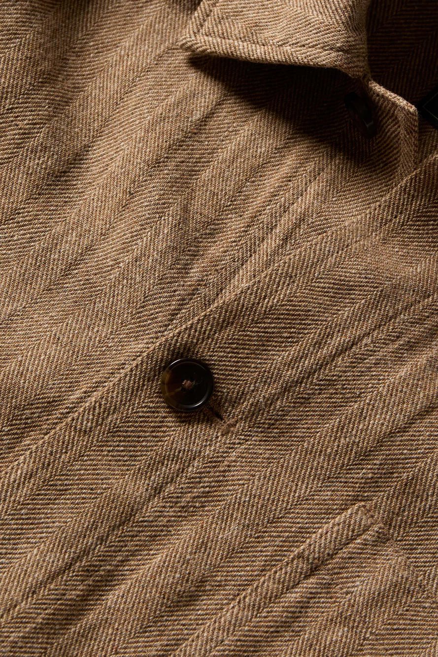Close-up of a brown textured fabric with a button