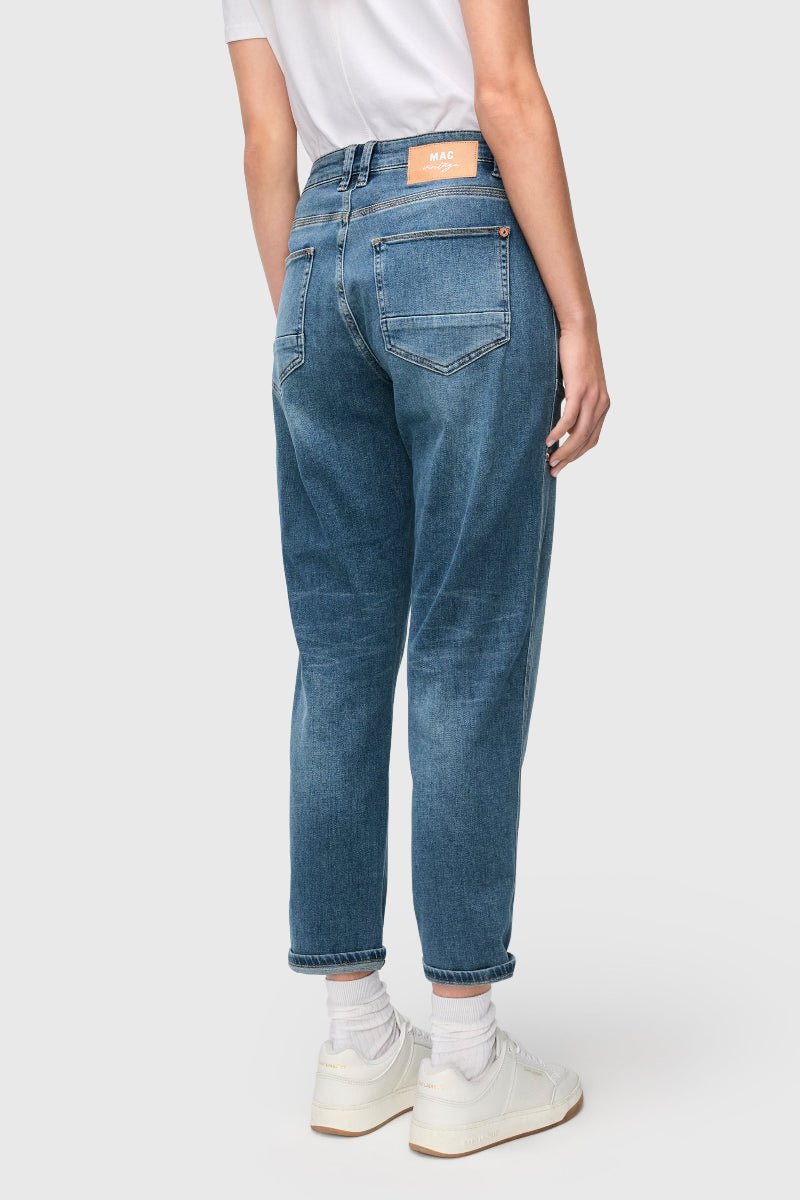 Person wearing blue jeans on a white background