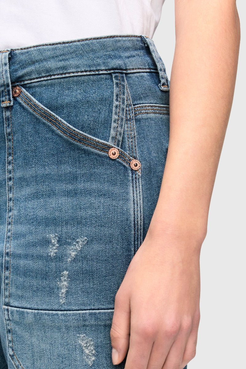 Close-up of blue jeans with a white background