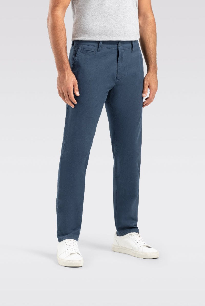 Person wearing blue pants on a light gray background