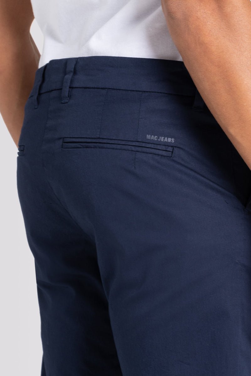 Navy blue pants with a visible brand logo on a plain background