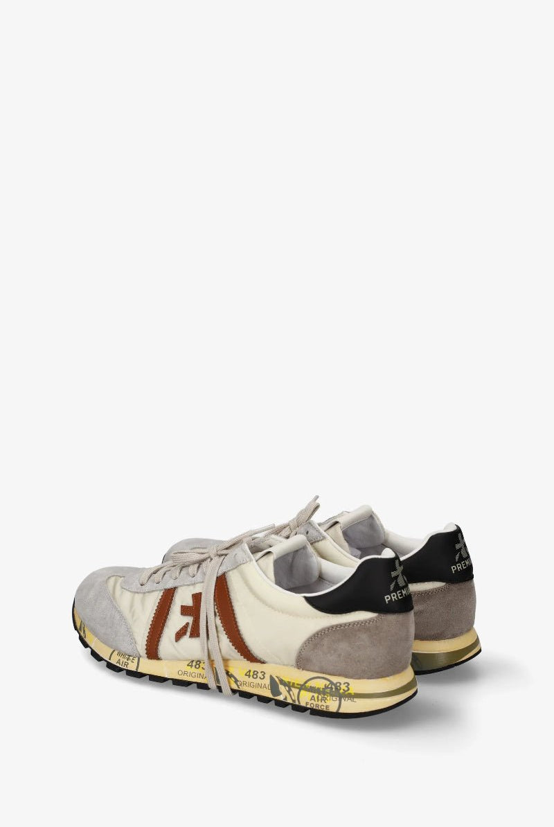 Pair of gray sneakers with brown and black accents on a white background