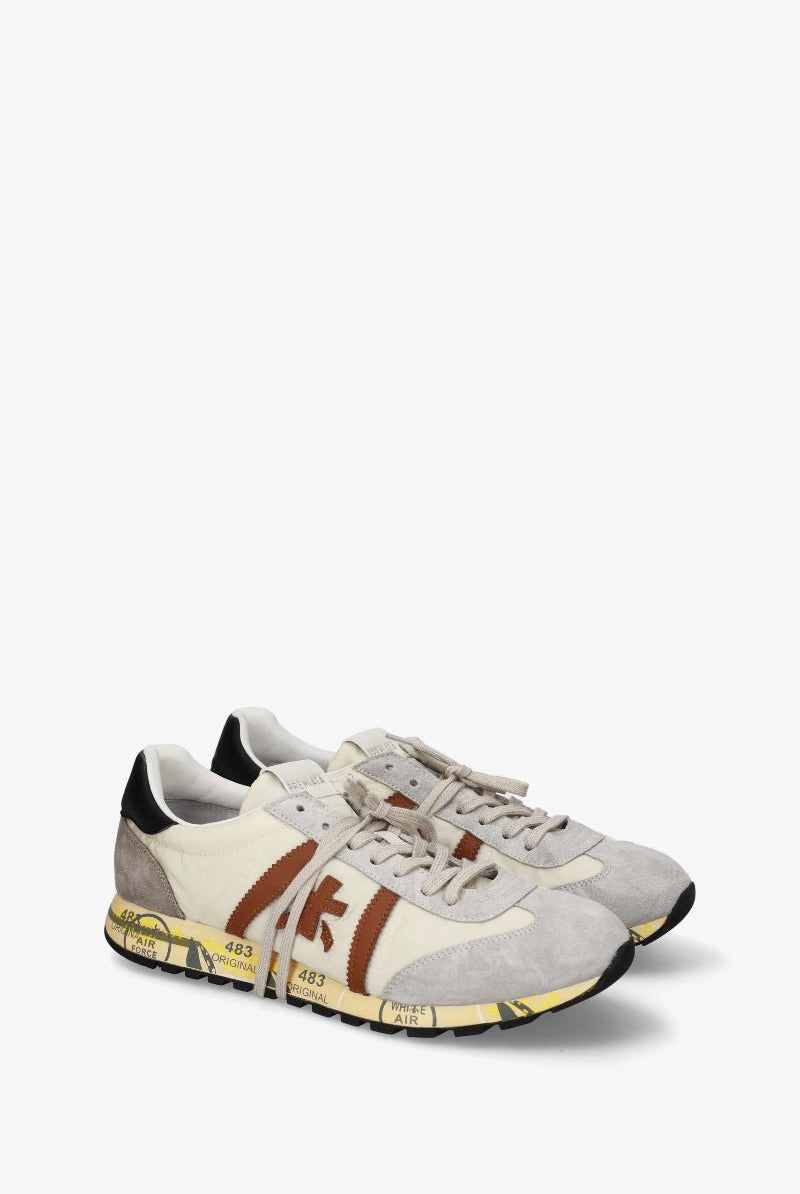 Pair of white sneakers with brown accents on a white background