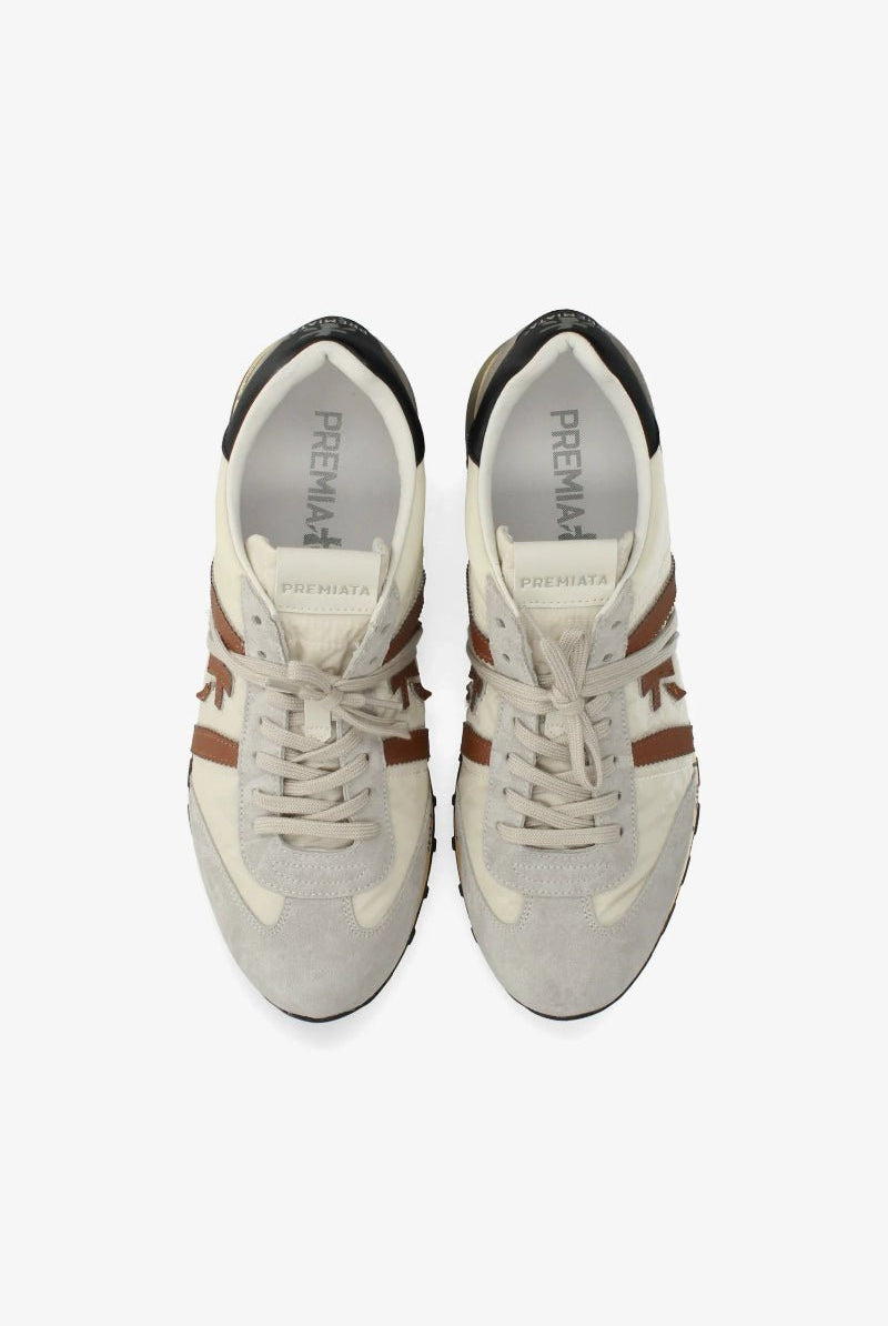 Pair of white sneakers with brown accents on a white background