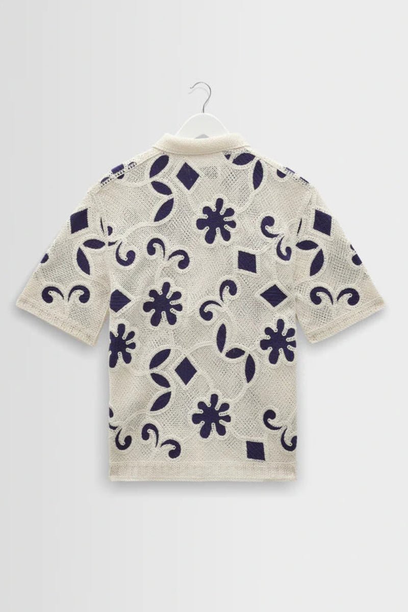 Short-sleeve shirt with floral pattern on a white background