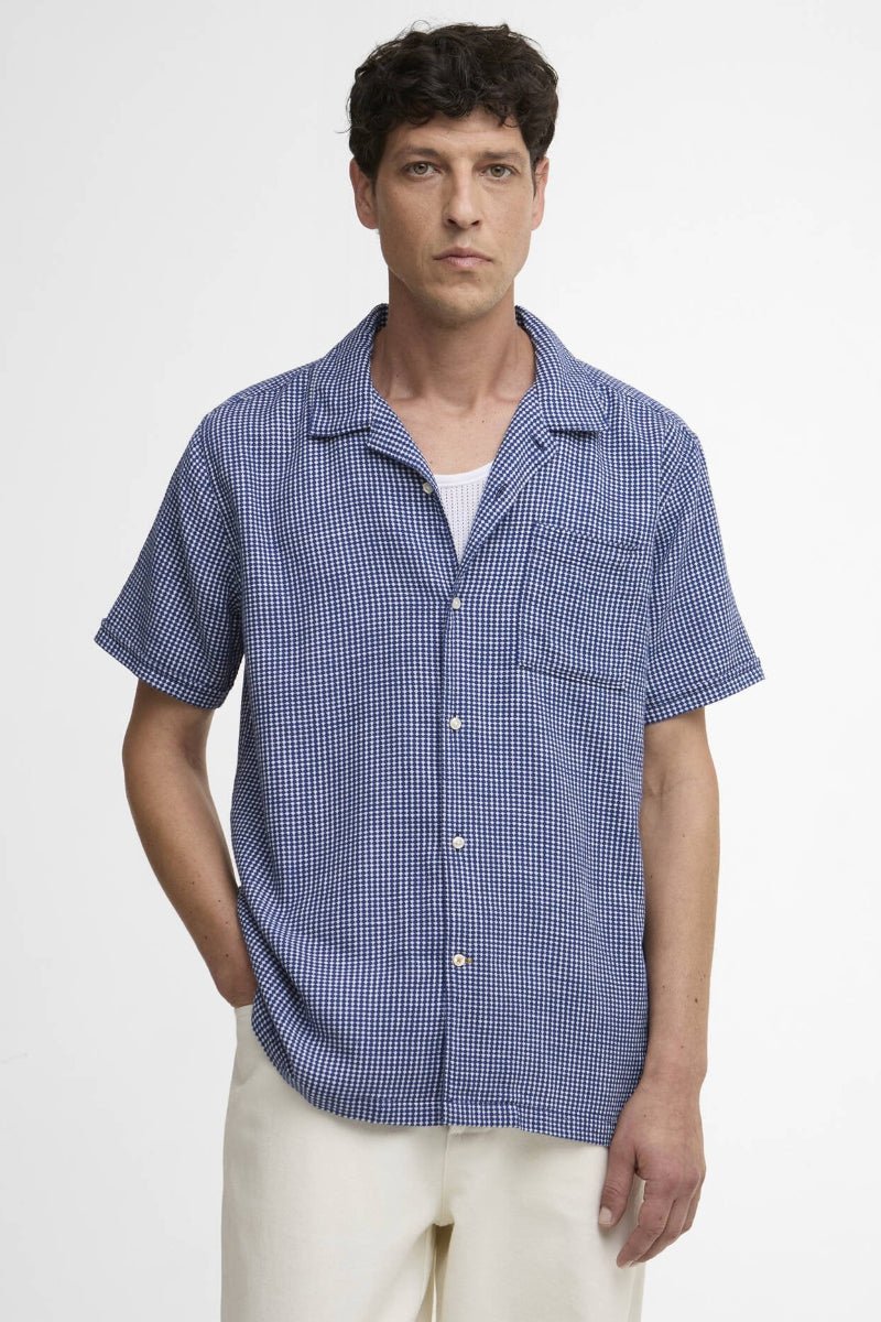 Man wearing a blue checkered shirt on a white background