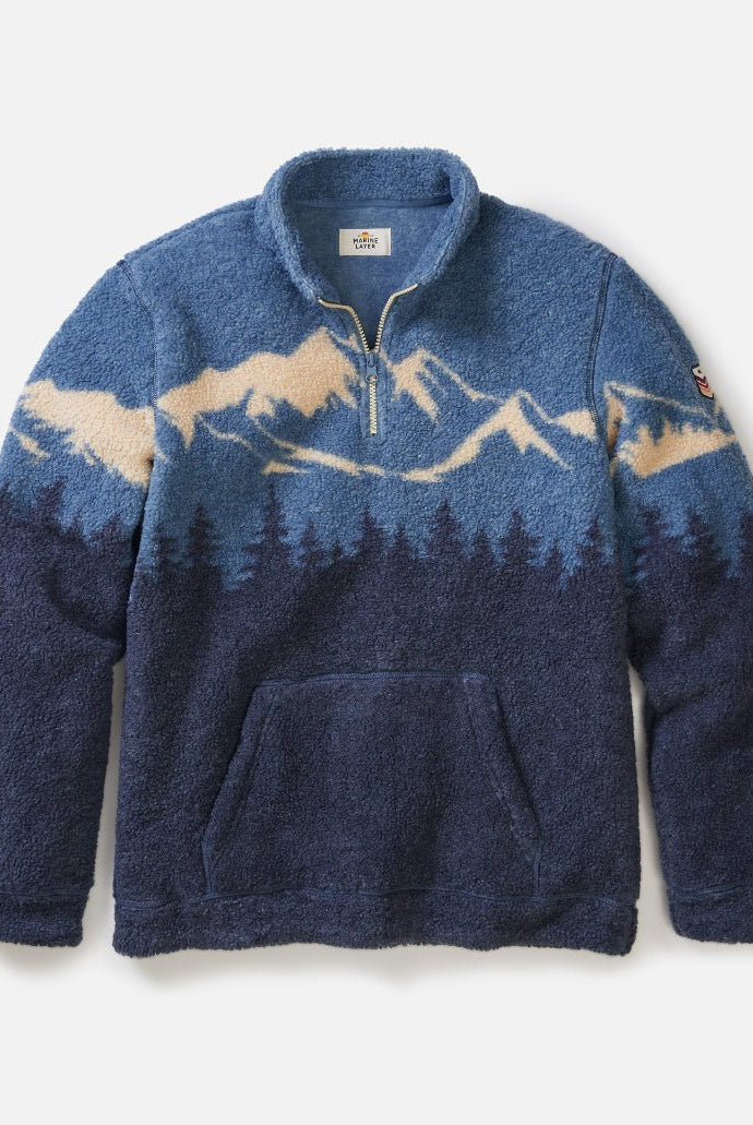 Blue fleece pullover with mountain design on a white background