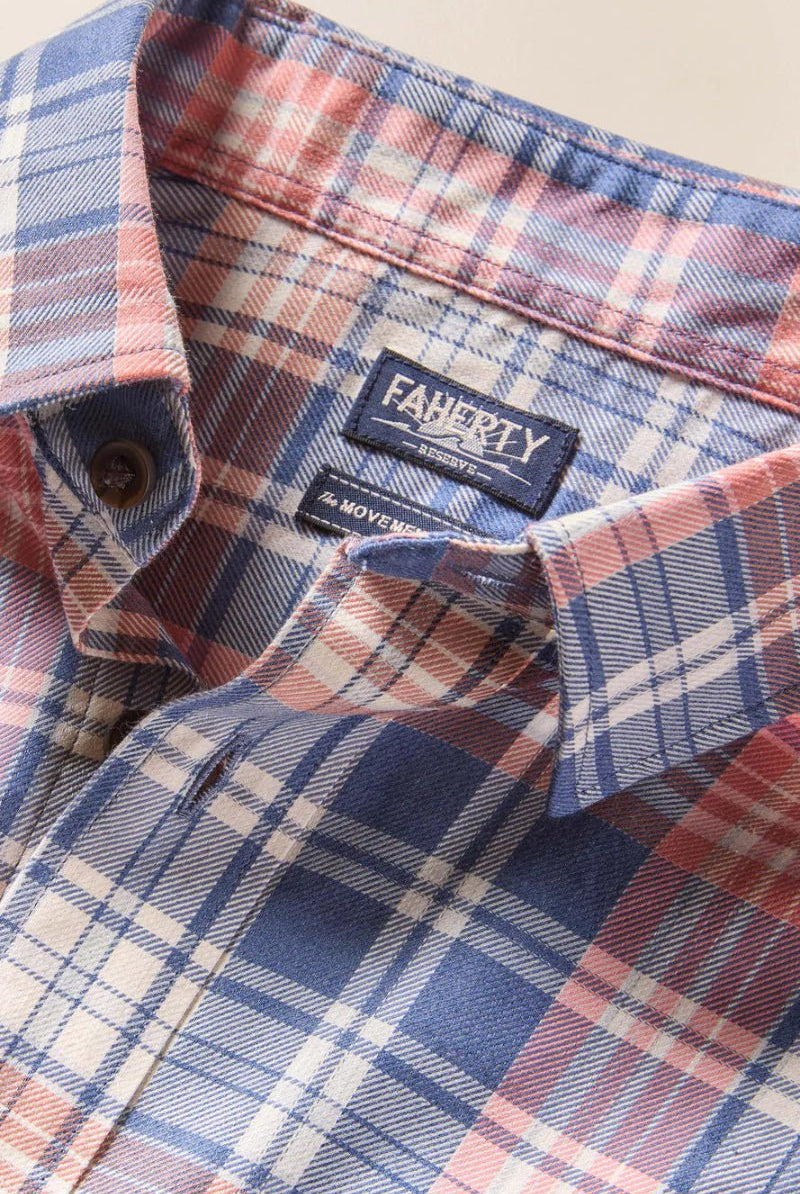 Close-up of a plaid shirt with a brand label on a beige background