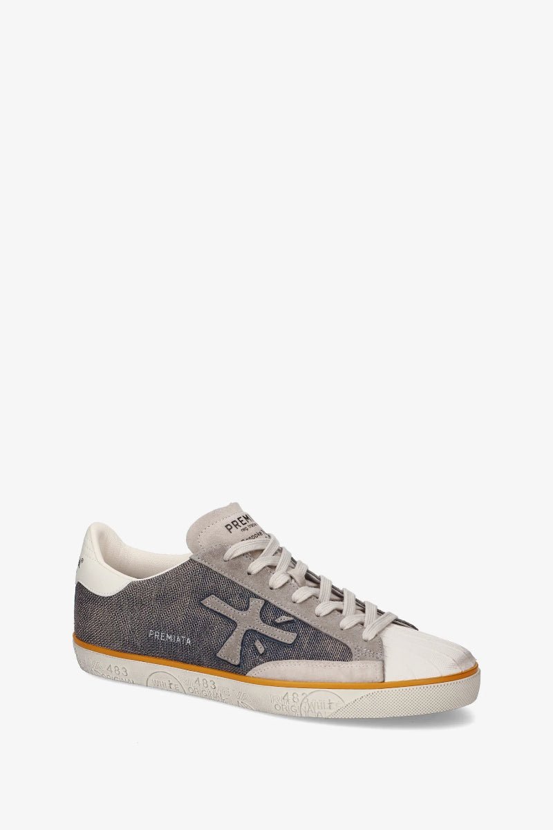 Gray and white sneaker with brand logo on a white background