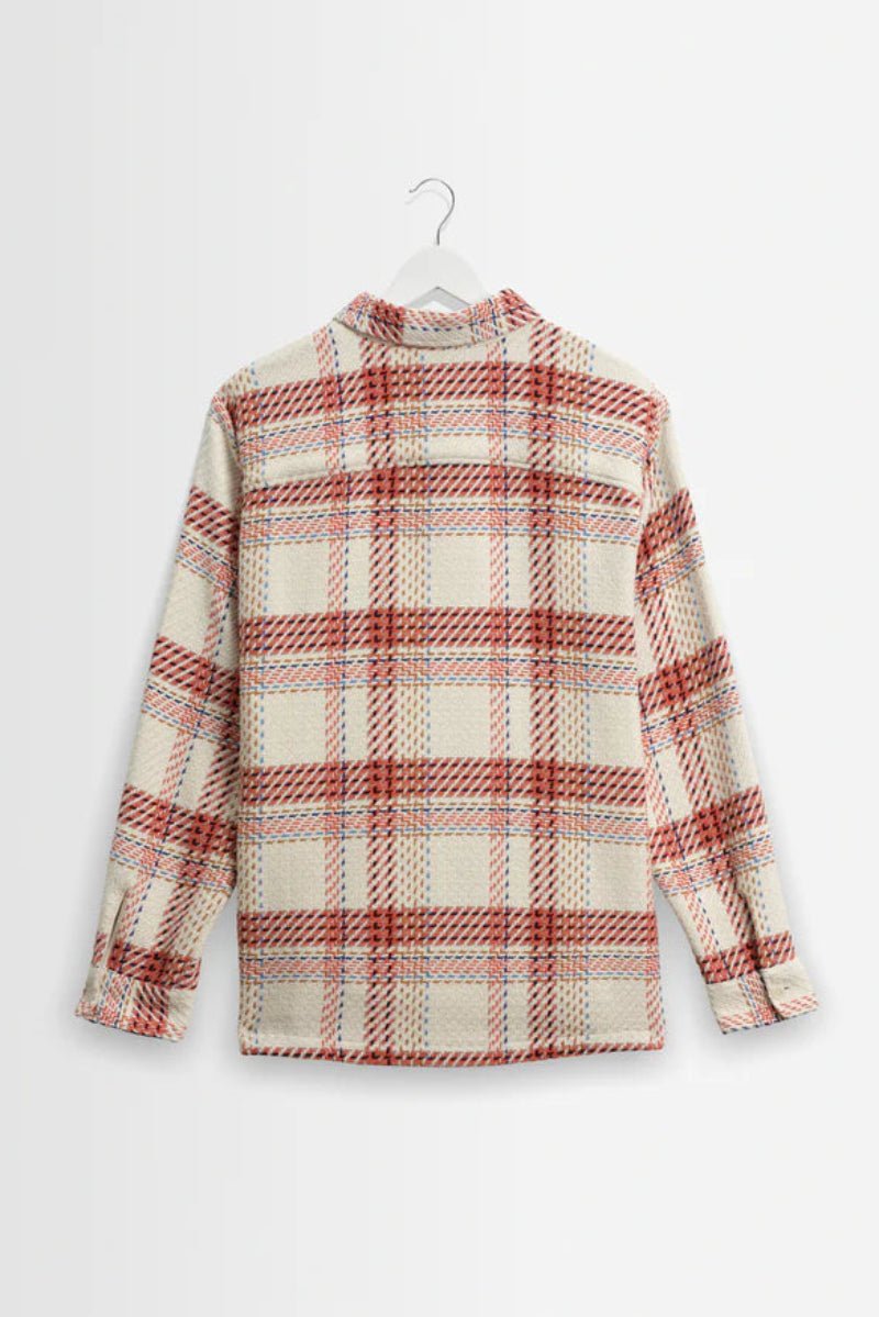 Plaid shirt on a hanger against a white background