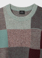 Patchwork sweater with a brand label on a white background