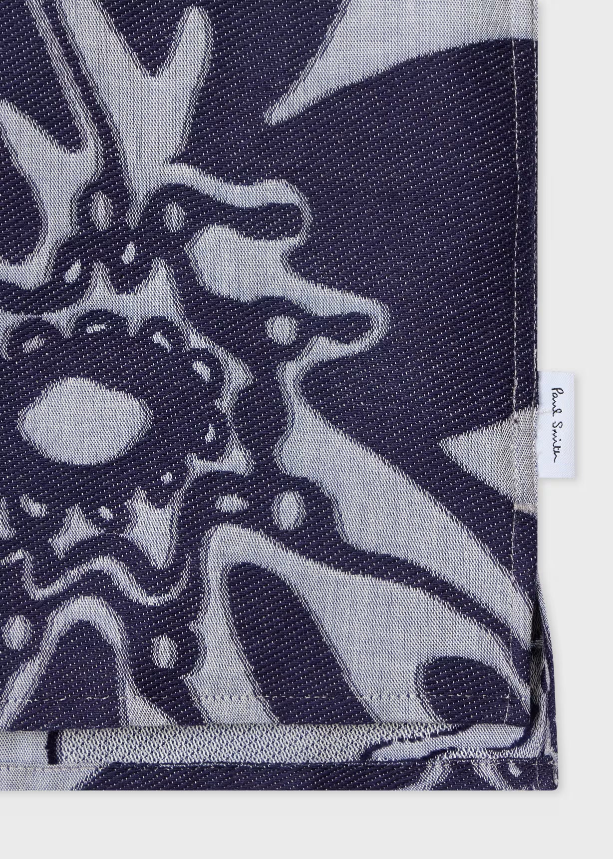 Navy blue and gray patterned fabric with a brand label on a white background