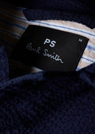 PS Paul Smith label on a textured fabric background