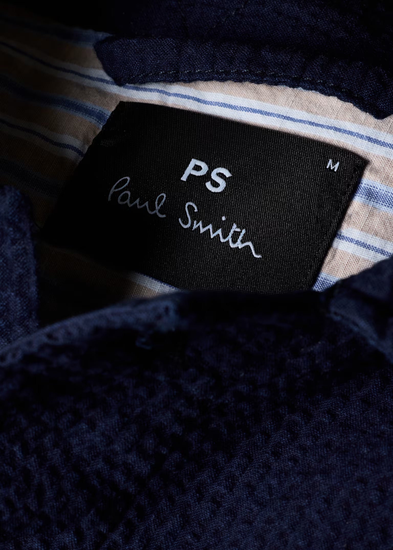 PS Paul Smith label on a textured fabric background