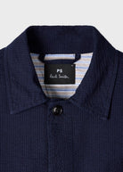 Navy blue textured shirt with a Paul Smith label on a light gray background