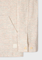 Close-up of a textured shirt with buttons on a light background