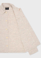 Beige button-up shirt on a light gray background