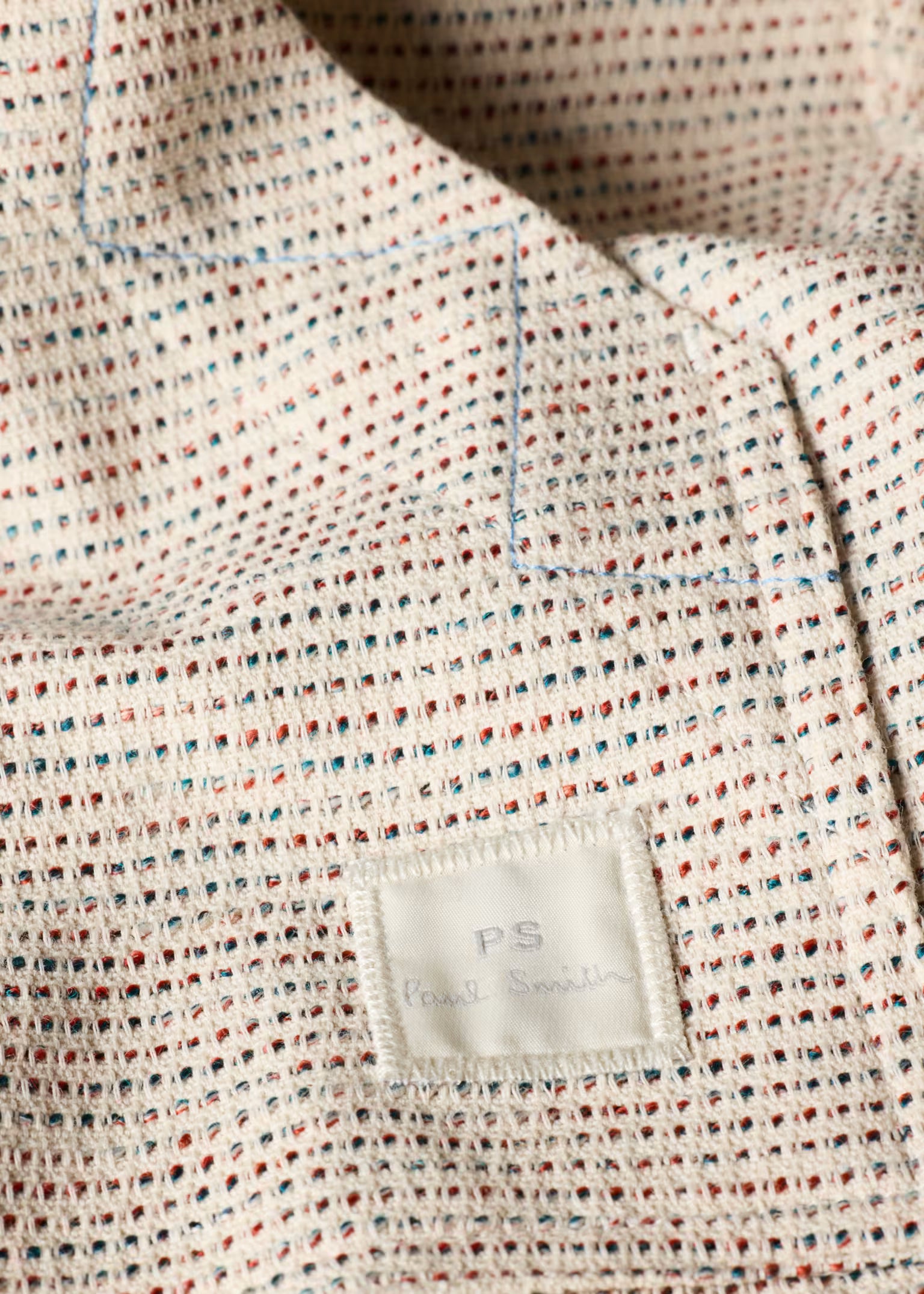 Textured fabric with a visible label on a neutral background