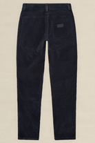 Rear view of dark navy corduroy trousers on a light beige background.