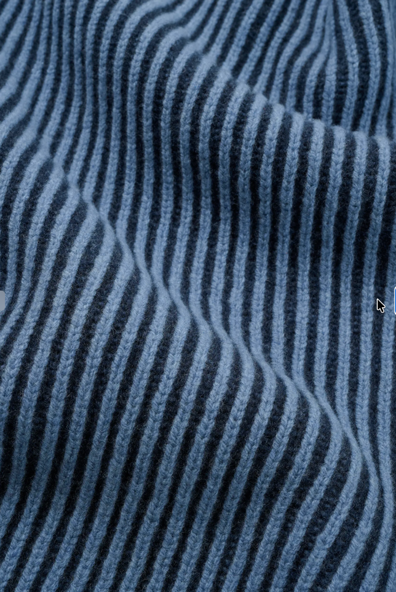A close-up of a blue and black striped knit fabric with a soft, ribbed texture.