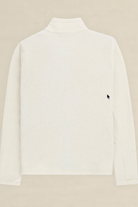 A white textured long-sleeve mock neck sweater shown from the back, featuring a small black embroidered mouse cursor logo on the left side, set against a solid beige background.