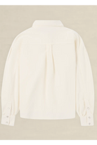 An off-white long-sleeve button-up shirt shown from the back, featuring a subtle pleat detail at the center back and buttoned cuffs, displayed against a neutral beige background.