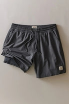 Pair of gray shorts on a light beige background